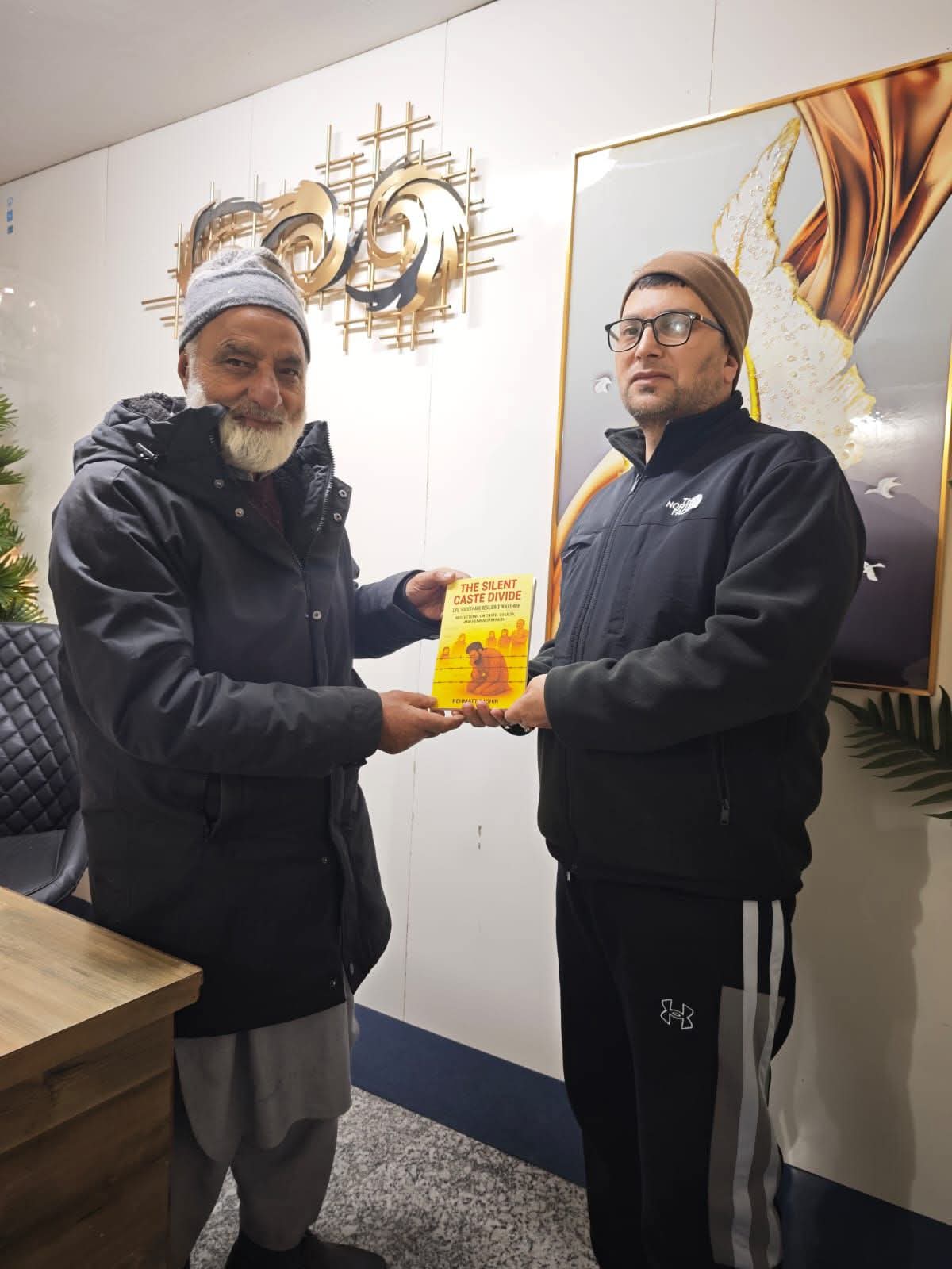 Rehmat Bashir presents his book to Patron Civil Society